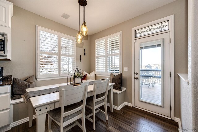 4968 Montvale Dr, Highlands Ranch, CO 80130 - dining area with dark wood-type flooring, baseboards, and visible vents