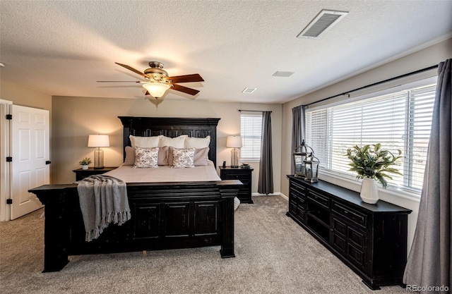 4968 Montvale Dr, Highlands Ranch, CO 80130 - bedroom with visible vents, ceiling fan, light colored carpet, and a textured ceiling