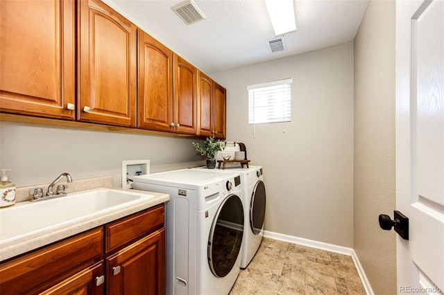 4968 Montvale Dr, Highlands Ranch, CO 80130 - laundry room with baseboards, visible vents, cabinet space, washer and dryer, and a sink