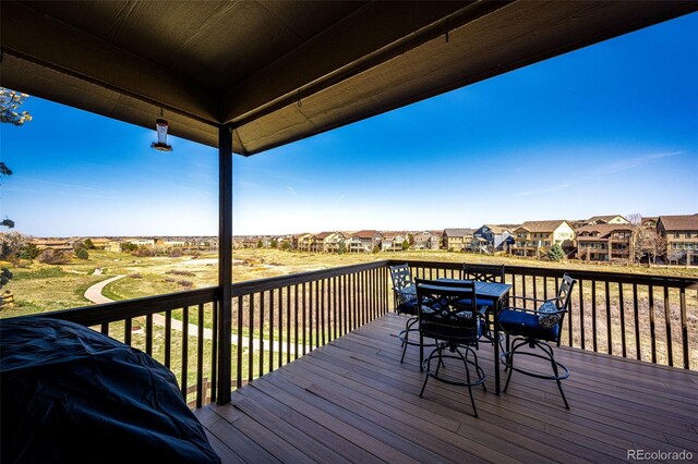4968 Montvale Dr, Highlands Ranch, CO 80130 - wooden deck featuring grilling area, outdoor dining area, and a residential view