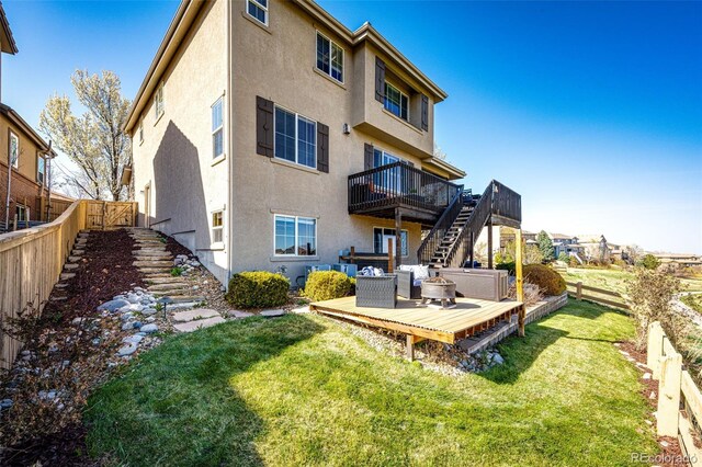 4968 Montvale Dr, Highlands Ranch, CO 80130 - back of property featuring a fenced backyard, stucco siding, a wooden deck, and stairs
