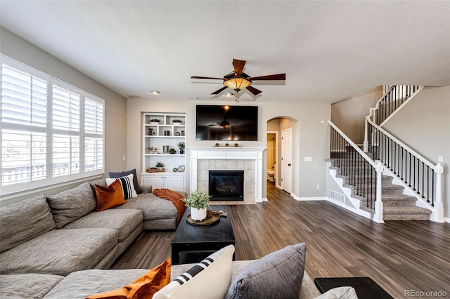 4968 Montvale Dr, Highlands Ranch, CO 80130 - living area with arched walkways, a textured ceiling, a ceiling fan, wood finished floors, and stairs