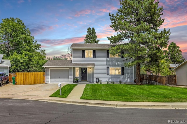 view of front of house with a garage and a yard