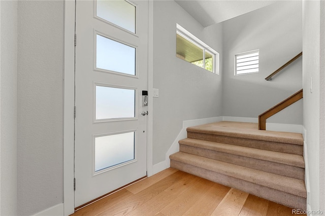 5988 N Boston St, Denver, CO 80238 - entryway with light wood finished floors and stairs