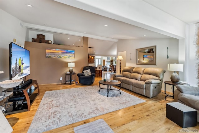 living area featuring wood finished floors, vaulted ceiling, and recessed lighting