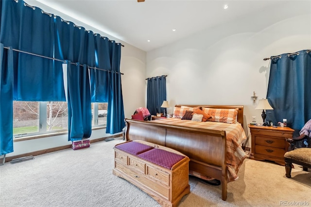bedroom with carpet floors, vaulted ceiling, and baseboards