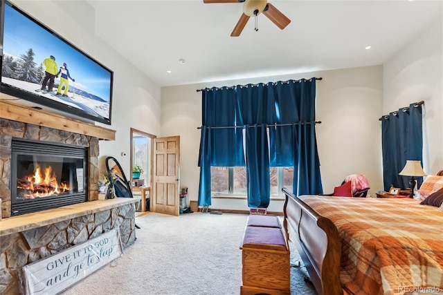 carpeted bedroom with a fireplace, a high ceiling, a ceiling fan, and baseboards