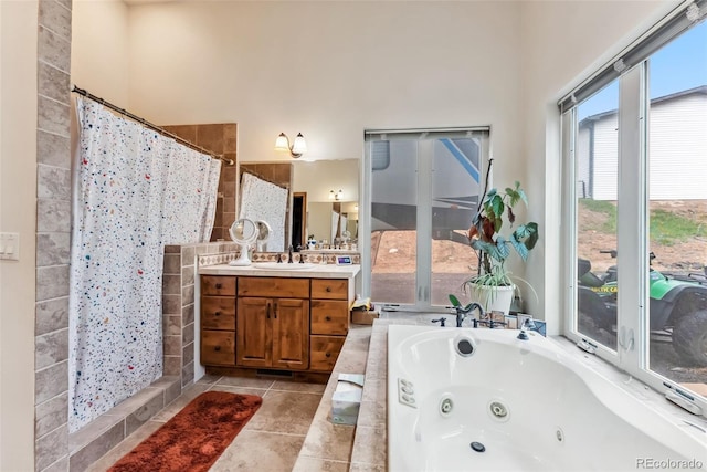 full bathroom featuring a tile shower, vanity, a whirlpool tub, and tile patterned floors