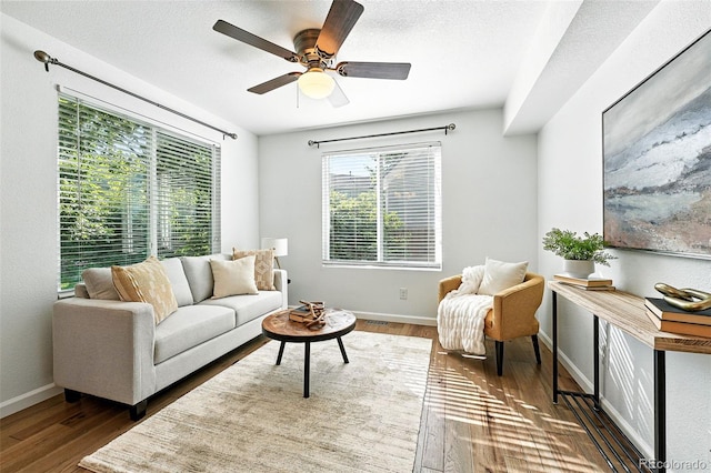 5193 S Flanders Ln, Centennial, CO 80015 - living area featuring healthy amount of natural light, wood finished floors, and a ceiling fan
