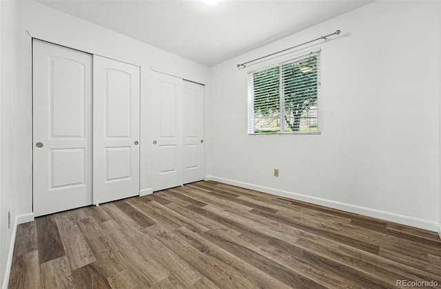 5193 S Flanders Ln, Centennial, CO 80015 - unfurnished bedroom with wood finished floors and baseboards