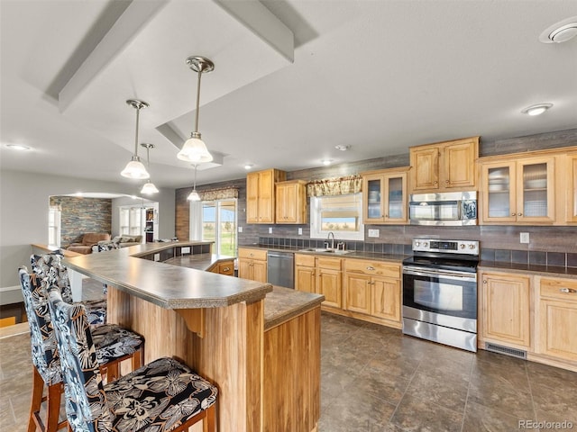 47855 E 88th Ave, Bennett, CO 80102 - kitchen with stainless steel appliances, a sink, a breakfast bar, and backsplash