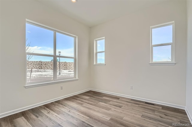 unfurnished room with plenty of natural light and light wood-type flooring