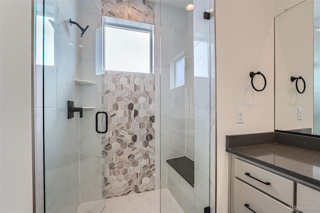 bathroom with vanity and a shower with door