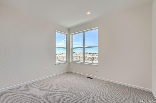 carpeted empty room with a water view and a view of the beach