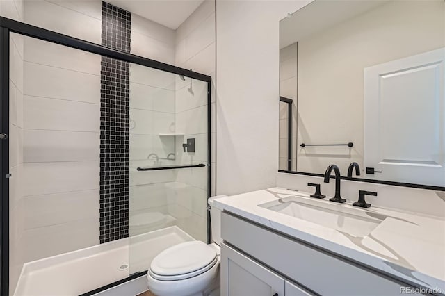 bathroom with vanity, toilet, and an enclosed shower