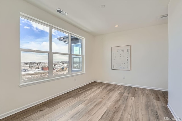 spare room featuring light wood-type flooring