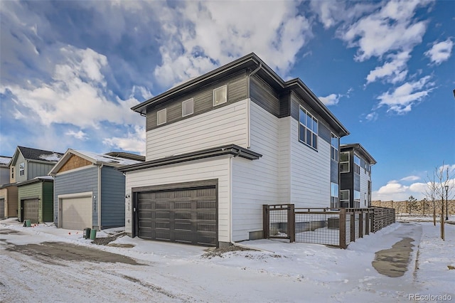 view of snow covered exterior with a garage