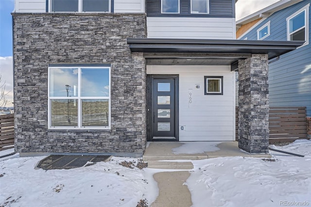 view of snow covered property entrance