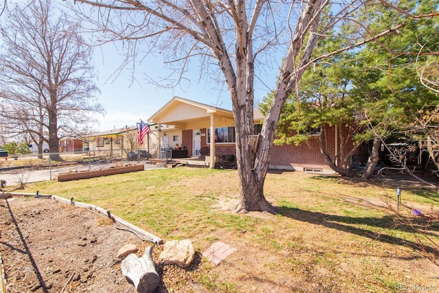 view of yard featuring covered porch and fence