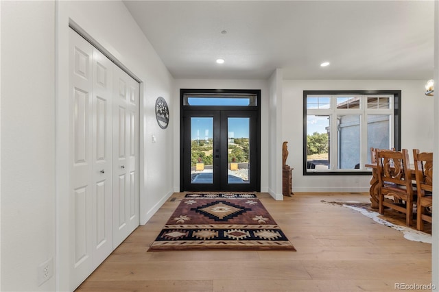 entryway with light hardwood / wood-style floors and french doors