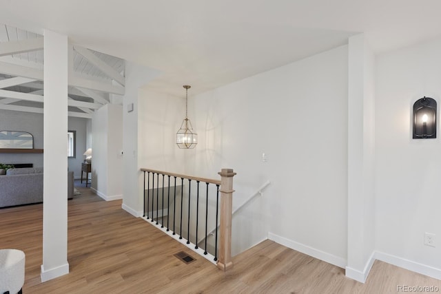 41 Eagle Dr, Littleton, CO 80123 - corridor featuring an upstairs landing, wood finished floors, baseboards, and a chandelier