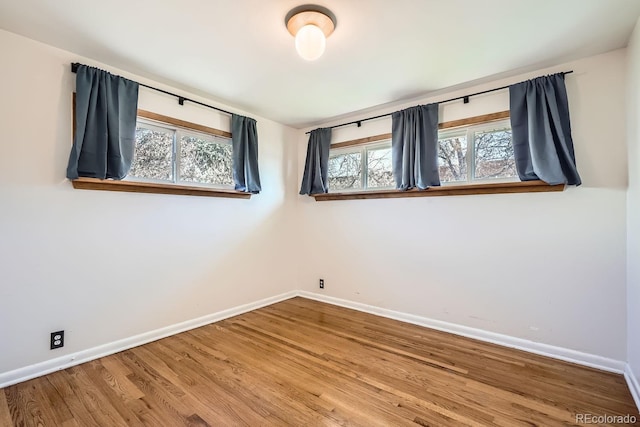 empty room with hardwood / wood-style floors