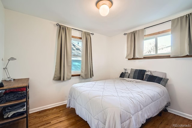 bedroom with dark hardwood / wood-style flooring