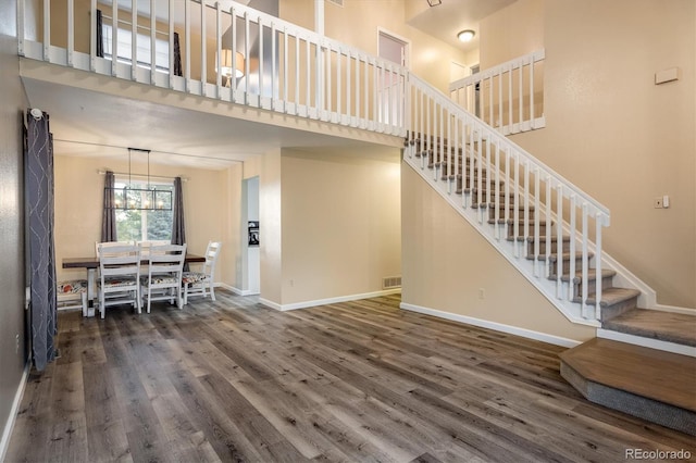 2777 W 106th Cir, Westminster, CO 80234 - living room featuring a towering ceiling, wood finished floors, and stairway