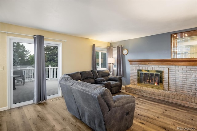 2777 W 106th Cir, Westminster, CO 80234 - living area with wood finished floors and a brick fireplace