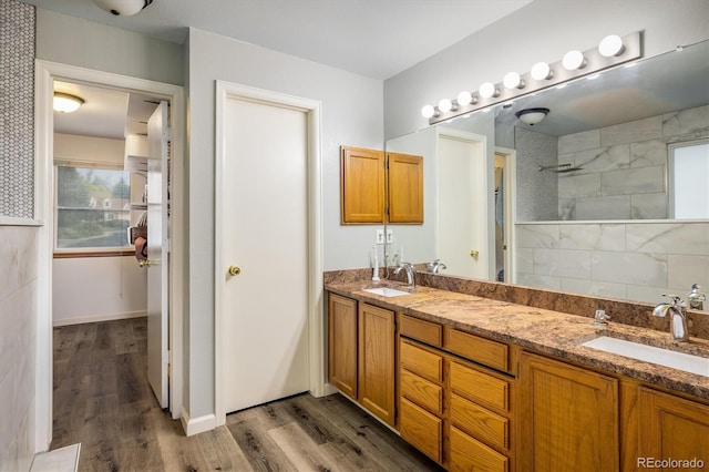 2777 W 106th Cir, Westminster, CO 80234 - bathroom with double vanity, wood finished floors, and tiled shower