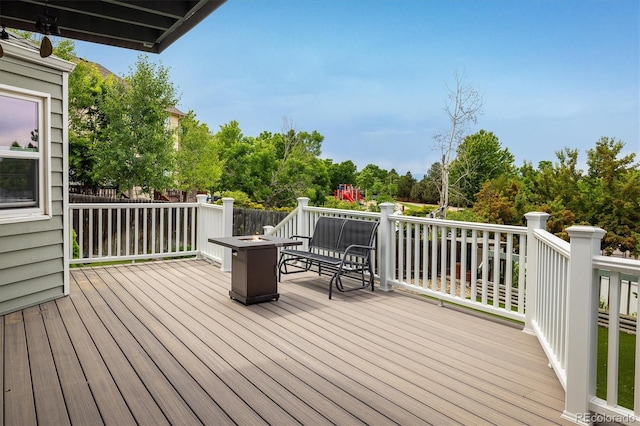 2777 W 106th Cir, Westminster, CO 80234 - wooden terrace with an outdoor fire pit and view of wooded area