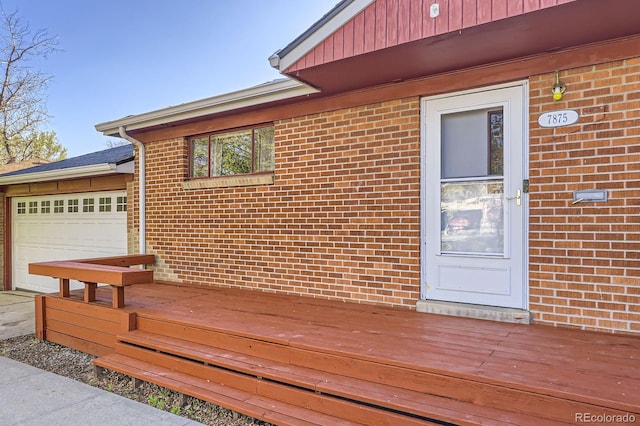 wooden terrace with a garage