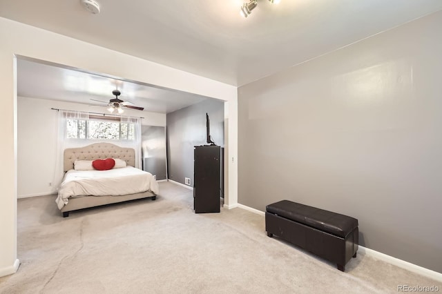 bedroom featuring carpet floors, baseboards, and a ceiling fan
