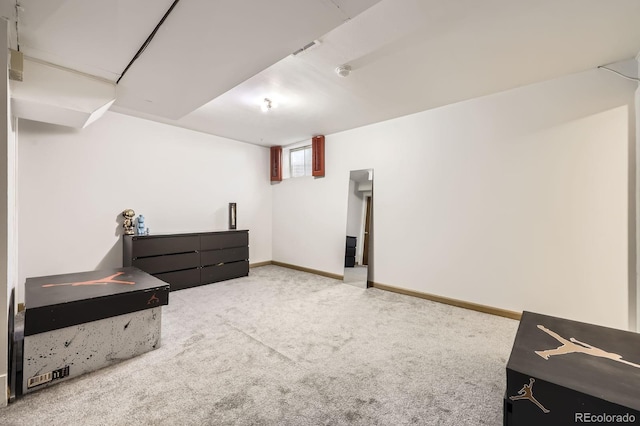 below grade area featuring carpet and baseboards