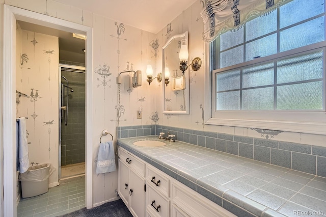bathroom with a stall shower, tile patterned flooring, and vanity