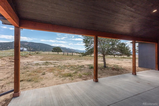 view of patio featuring a mountain view and a rural view