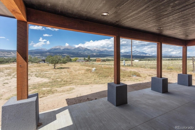 view of patio with a mountain view and a rural view