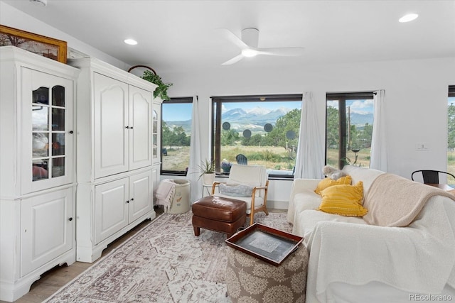 sitting room with hardwood / wood-style flooring and ceiling fan