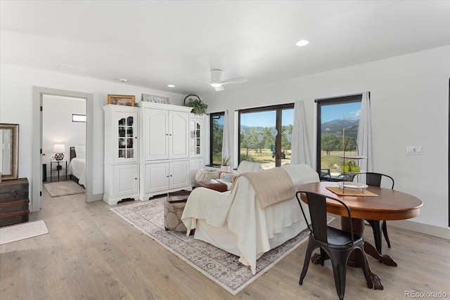 bedroom featuring ceiling fan, light hardwood / wood-style flooring, and french doors