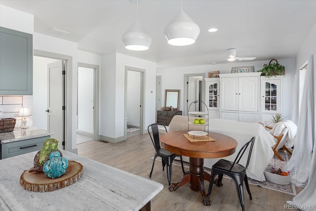 dining area featuring ceiling fan and light hardwood / wood-style flooring