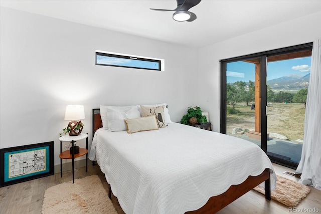 bedroom with hardwood / wood-style flooring, ceiling fan, and access to outside