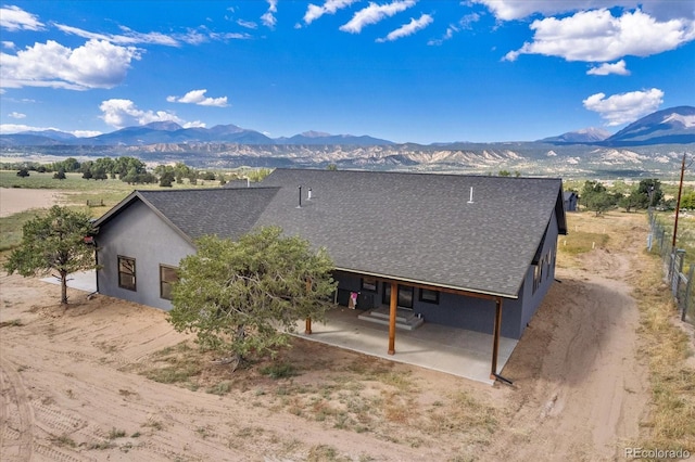 rear view of house featuring a patio area and a mountain view