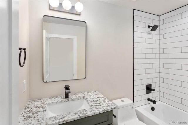 full bathroom featuring vanity, toilet, and tiled shower / bath