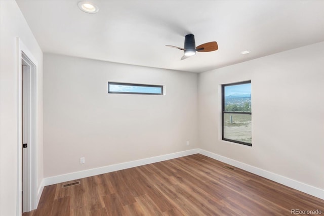 spare room with hardwood / wood-style flooring, ceiling fan, and a wealth of natural light