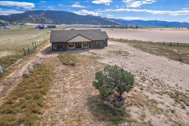 birds eye view of property featuring a mountain view and a rural view