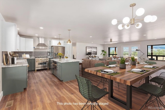 dining space with hardwood / wood-style flooring, ceiling fan, and french doors