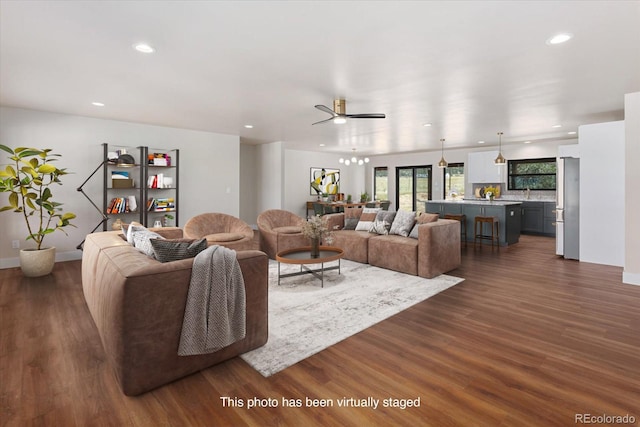 living room with dark hardwood / wood-style flooring and ceiling fan