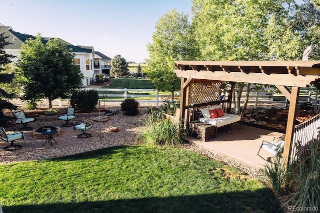 view of yard with a pergola and a fire pit