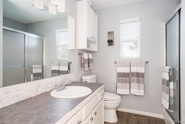 bathroom featuring vanity, hardwood / wood-style floors, and toilet