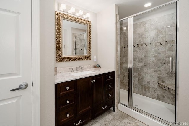 bathroom featuring tile patterned flooring, walk in shower, and vanity